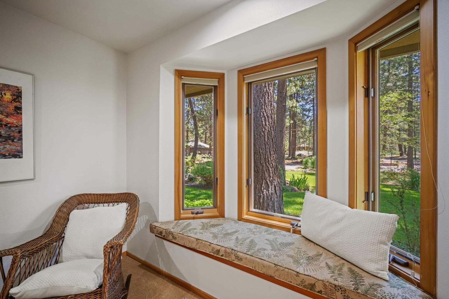Cozy bay window in this guest room for reading and enjoying views of nature.