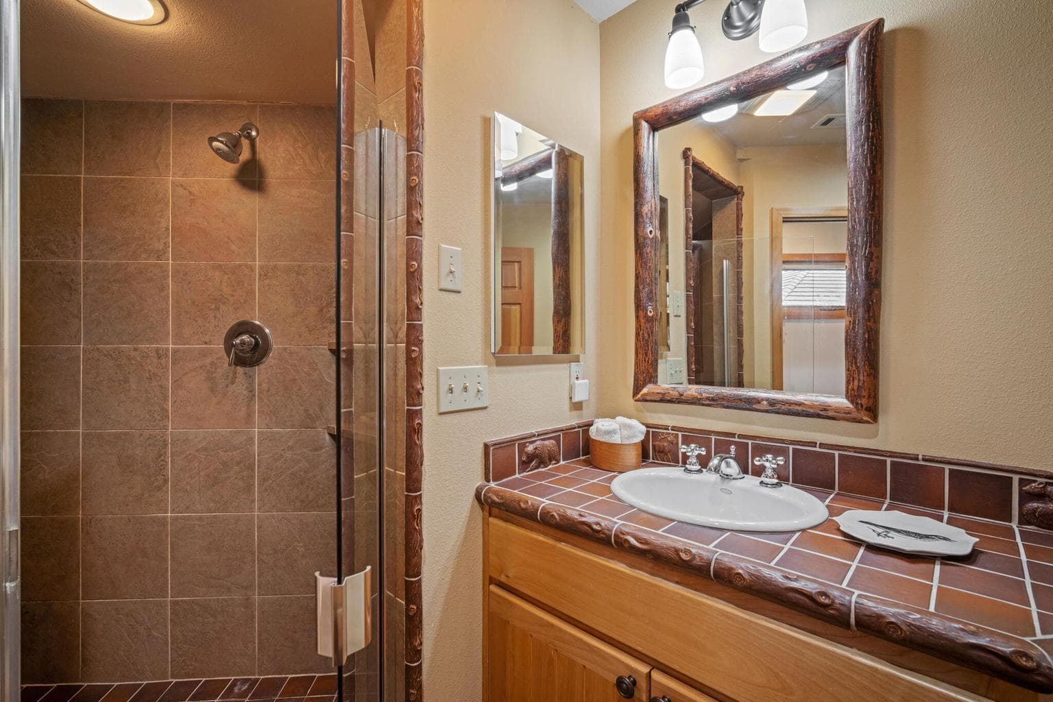 Full bath on the main level with walk-in, tiled shower and enclosed toilet.