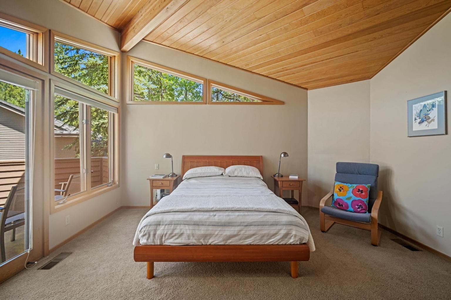 The primary suite is the 4th bedroom and located upstairs on it's own level. Custom windows frame the tree top views from your bed.