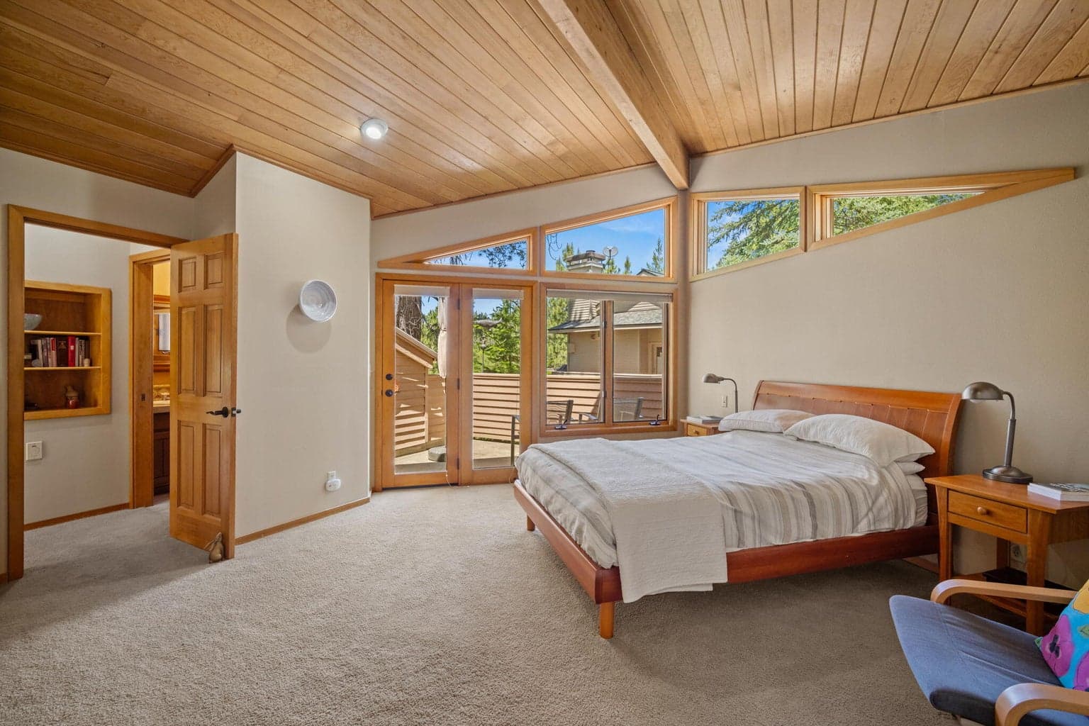 A view back to the entrance into the primary suite - a lovely wall of windows lets the sun right in for nature's wake up call.