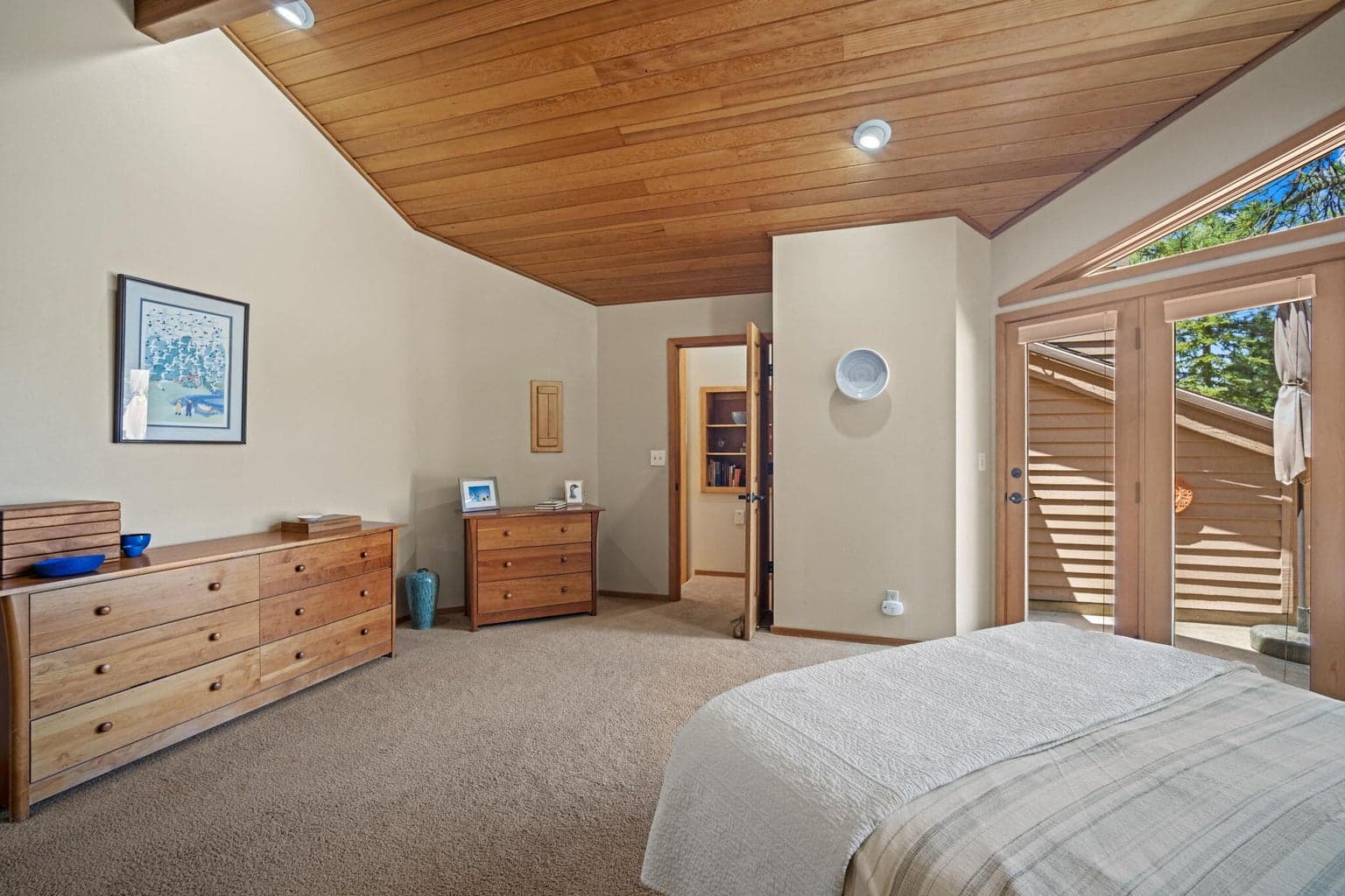 Primary suite, view back to the entrance and door to the upper, private deck.