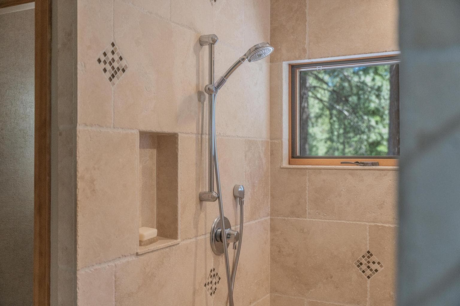 Close-up of travertine shower.