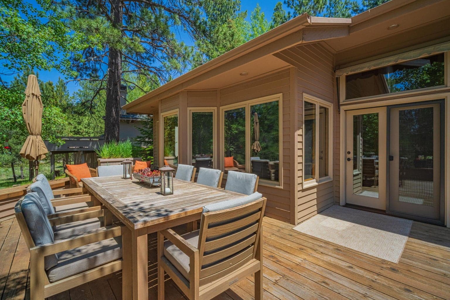 A view a the edge of the deck back towards the house, all the windows to the interior and an awning to take the heat off during Sunriver summers.