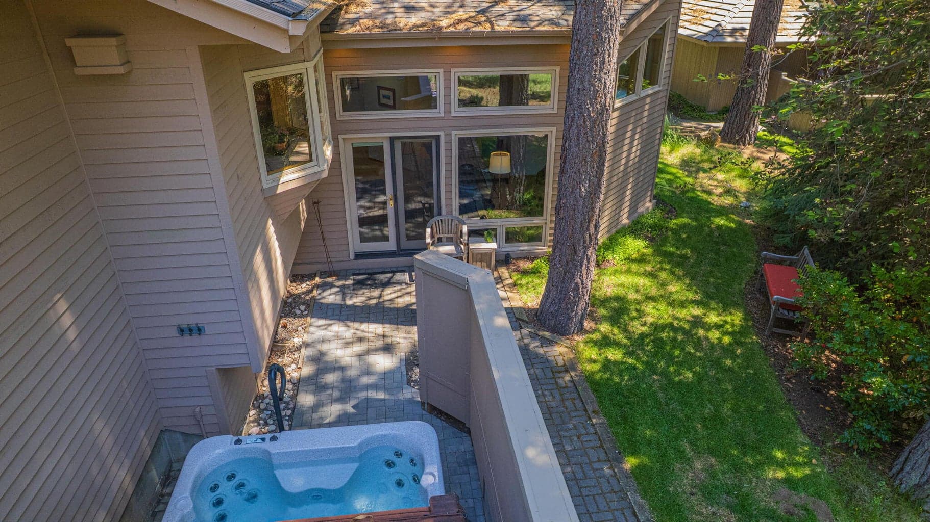 Bird's eye view of the hot tub area, the location of the back patio of the south end of the house and manicured grounds.