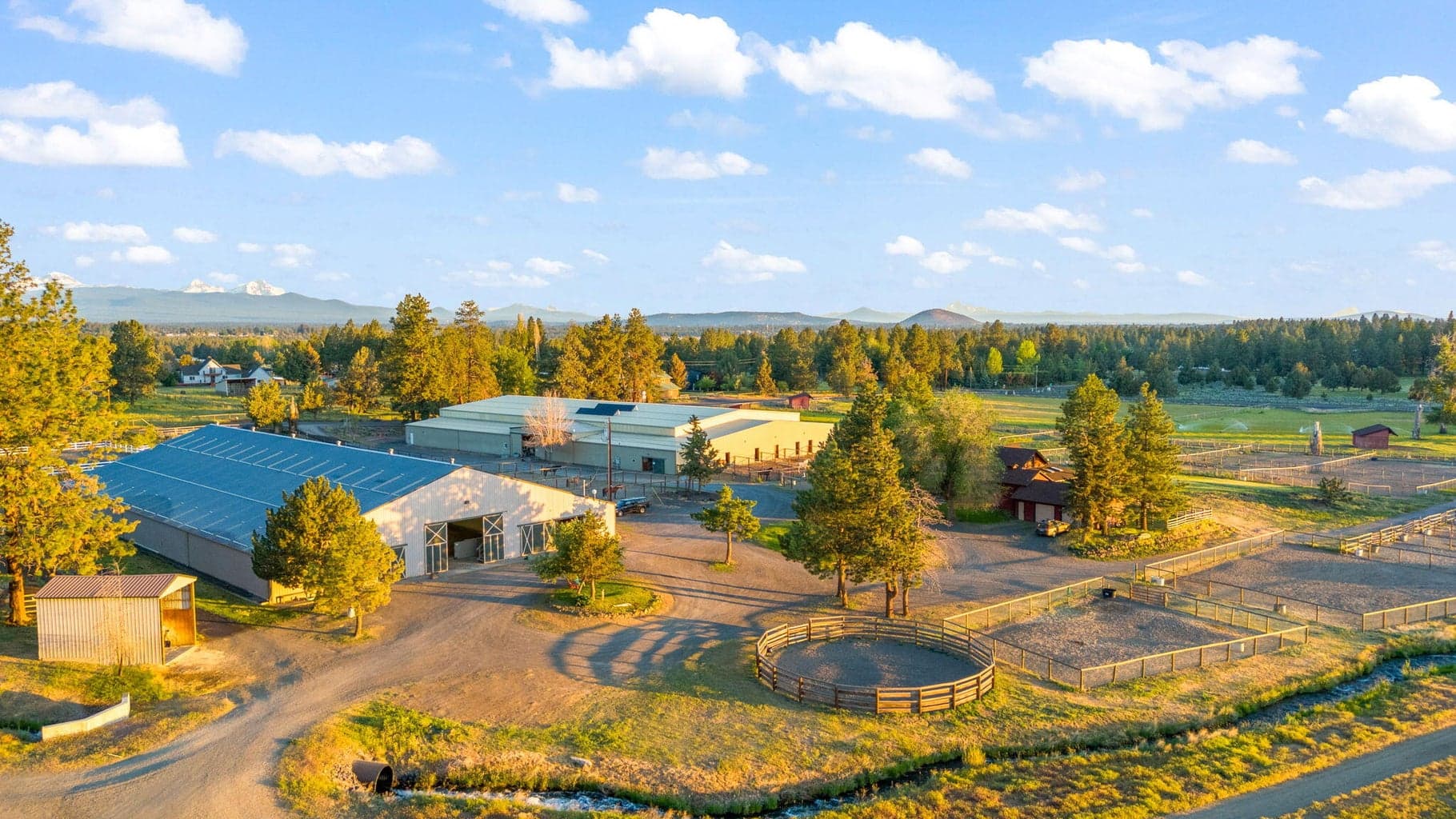 Horse Butte Farms, 53-acres (3) parcels 60+ Horse capacity on property. 31,000sf Jumping Barn, 21,000sf Barn/Arena, Outdoor sand arena, remodeled farmhouse, guest yurt 6-pad powered RV/trailer site and additional listing MLS 220205704 CUP build-site (on a 9-acre separate tax parcel)