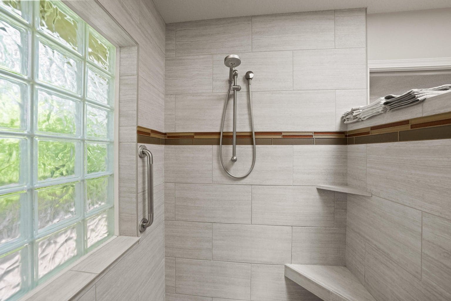 Owners get to enjoy a primary bathroom with a fully tiled shower and abundant natural light.