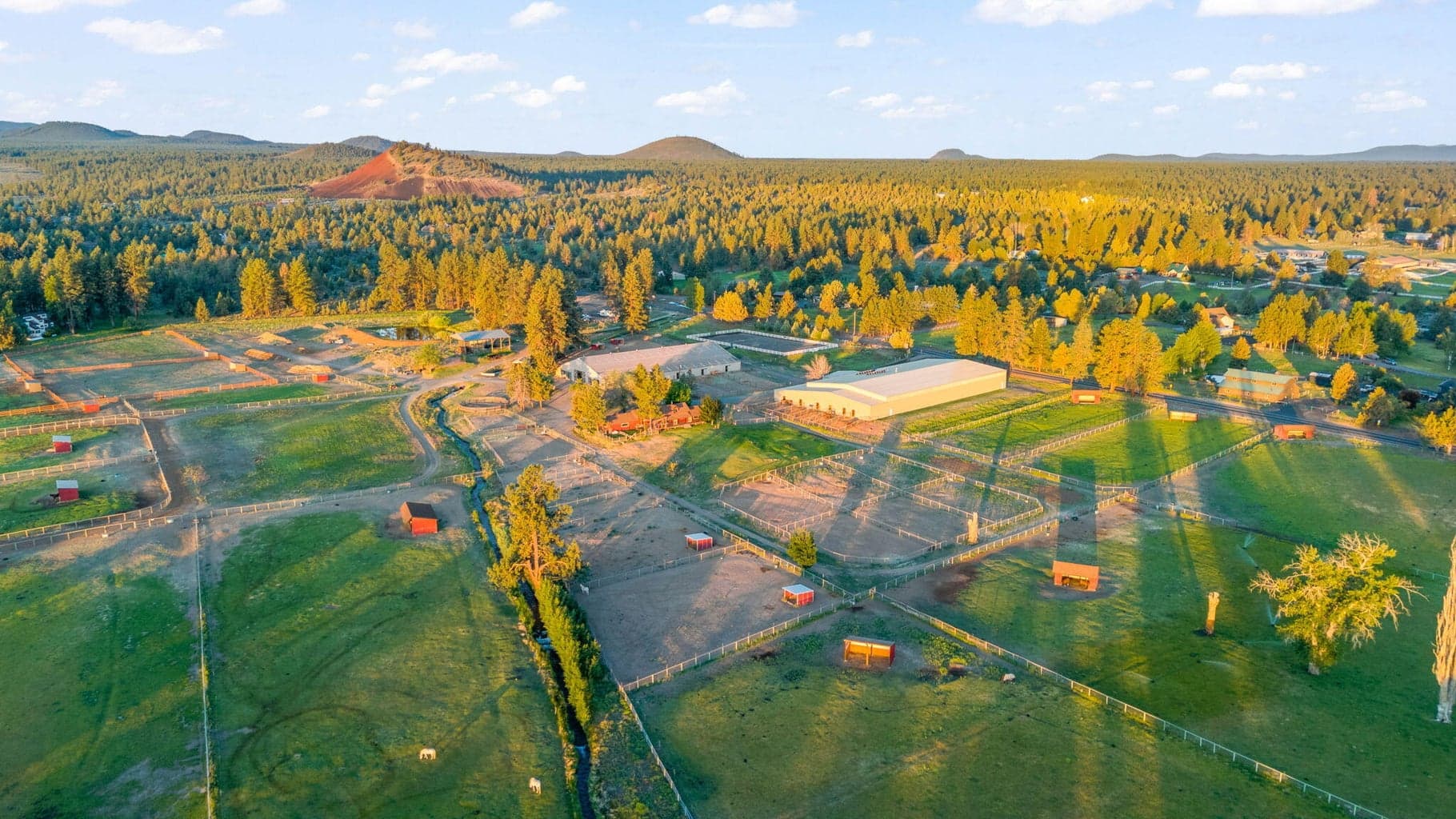 Horse Butte Farms, 53-acres (3) parcels 60+ Horse capacity on property. 31,000sf Jumping Barn, 21,000sf Barn/Arena, Outdoor sand arena, remodeled farmhouse, guest yurt 6-pad powered RV/trailer site and additional listing MLS 220205704 CUP build-site (on a 9-acre separate tax parcel)