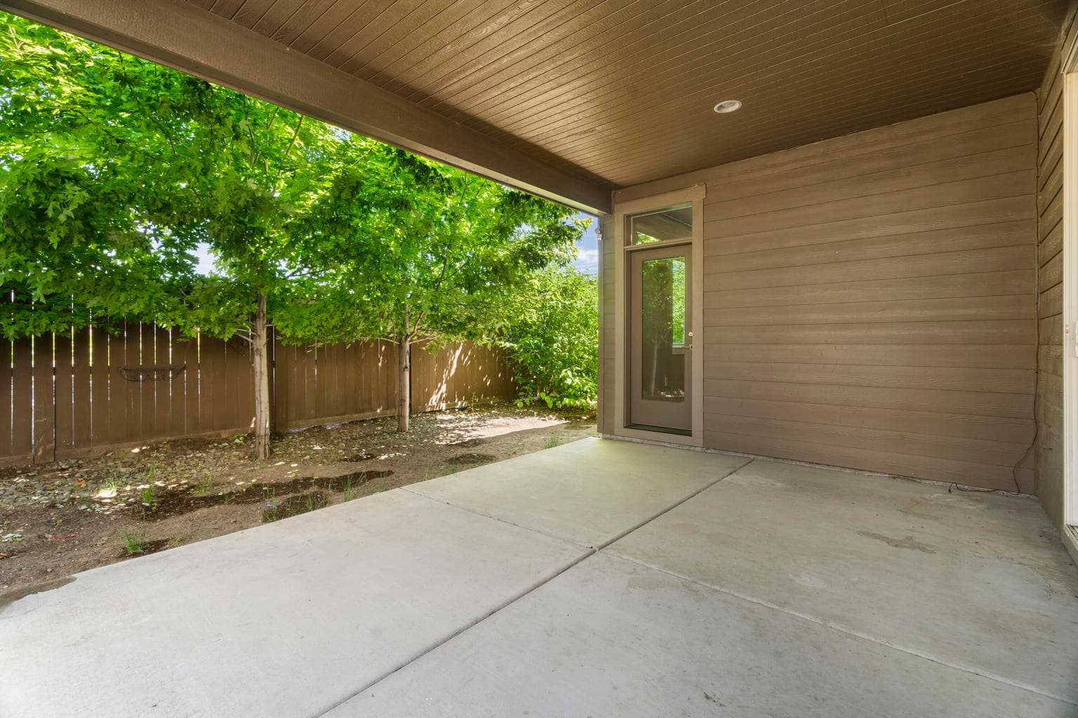 Covered back porch with door to primary bedroom