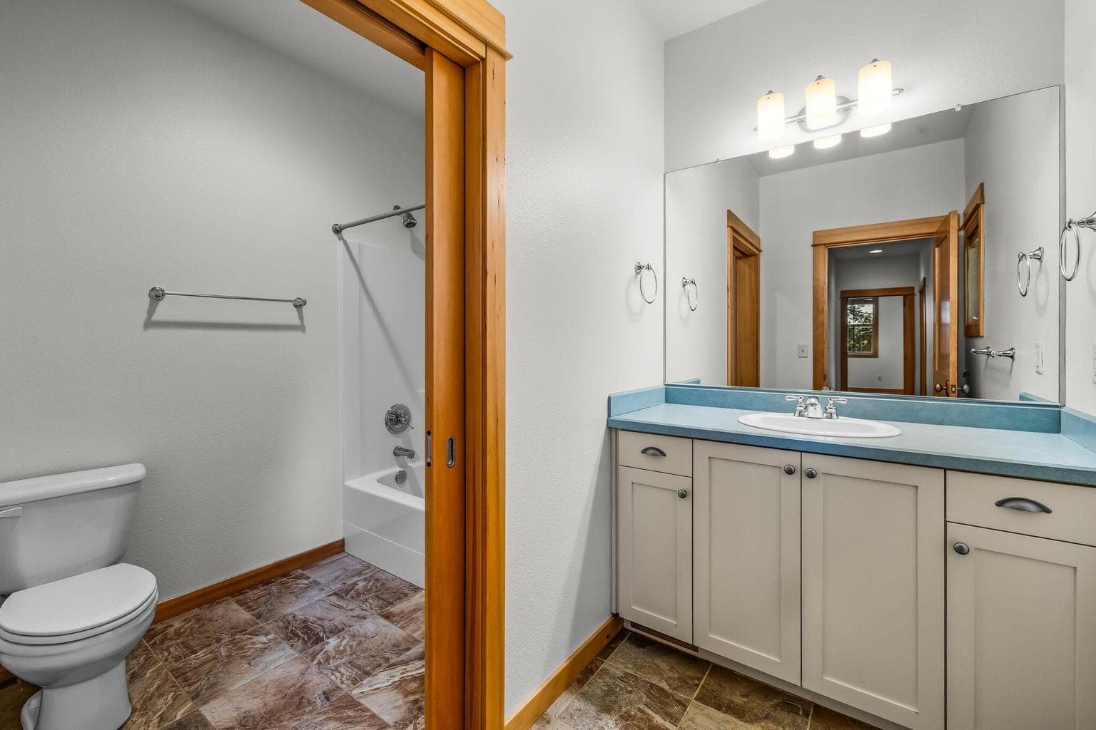 Upper hall bath with separated tub shower.
