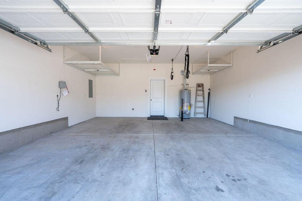 Garage with upper storage racks and attic floored storage