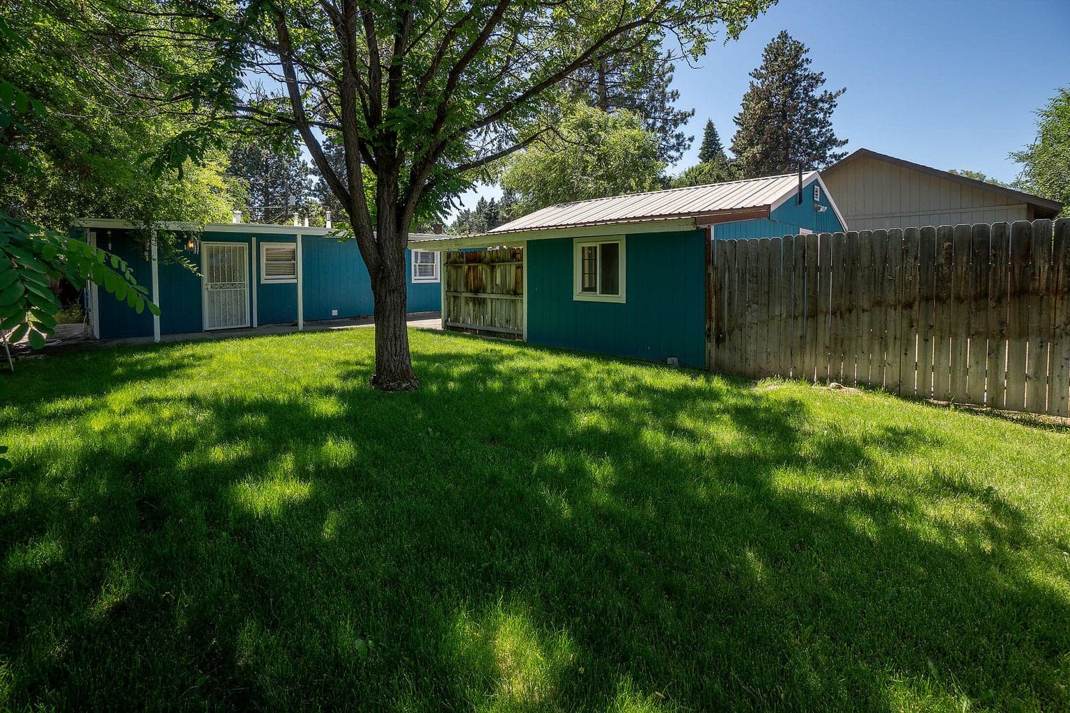 Fenced back yard with plenty of room for entertaining, playing, or pets. All-in-all this mid-town cutie is sweet, charming, and so liveable!