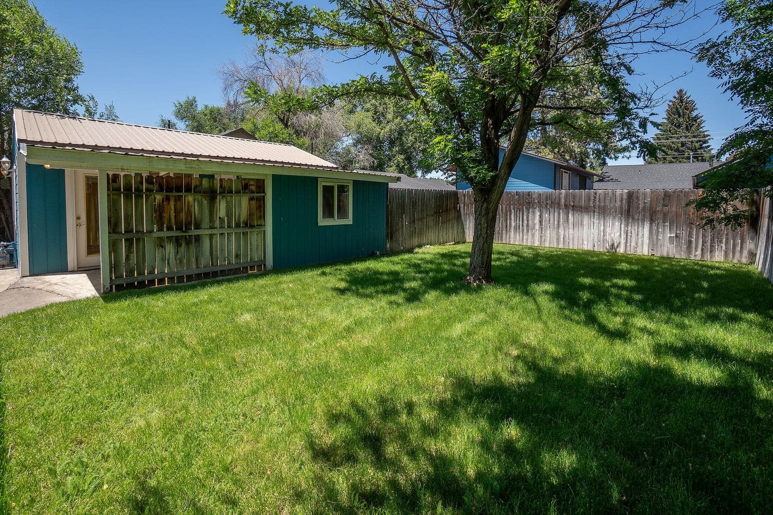 Back yard is fenced and includes nice patios, covered and uncovered. The yard is fenced, gated, and sprinkled.
