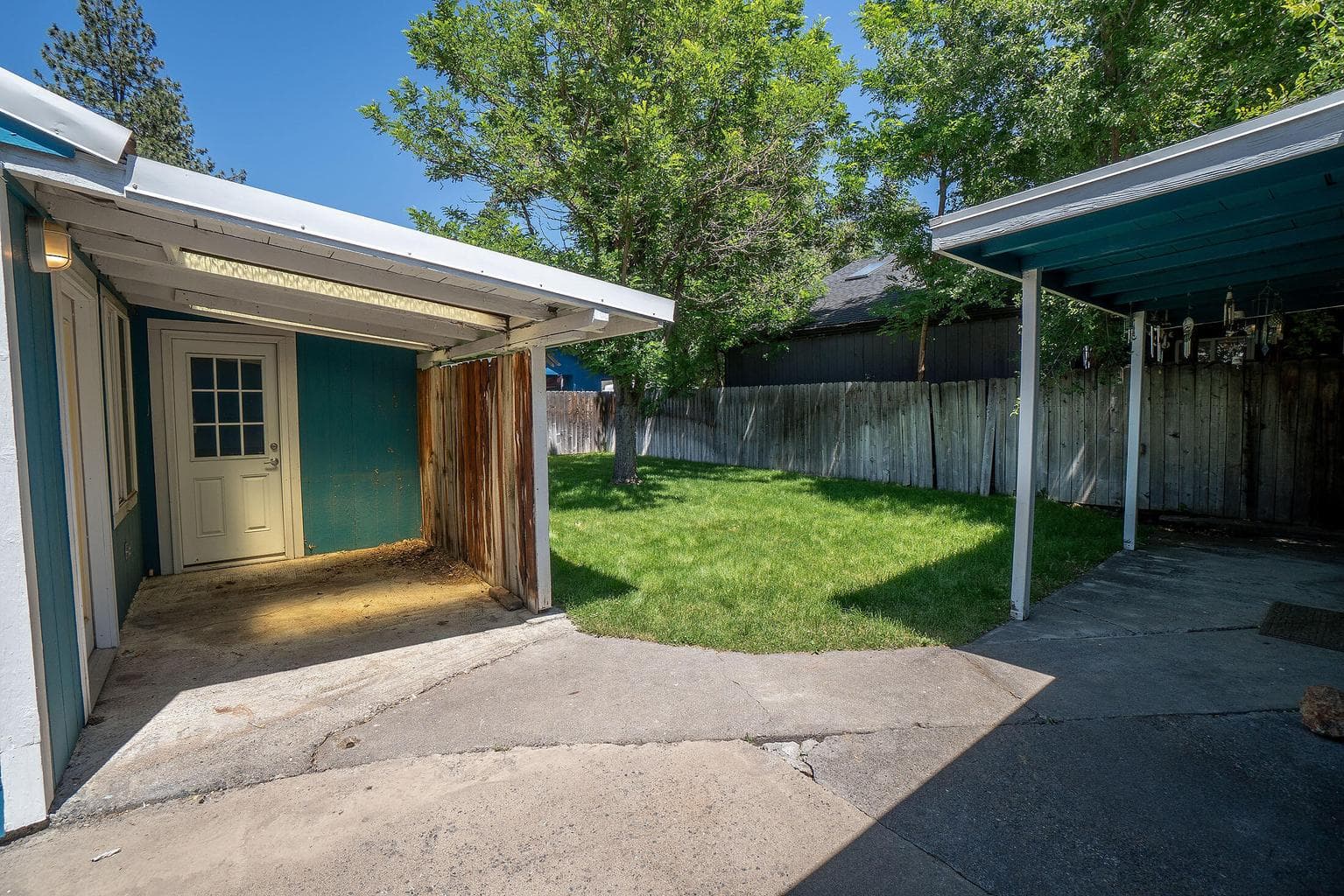 Covered patio area and door to the attached storage unit beside the studio guest cottage.