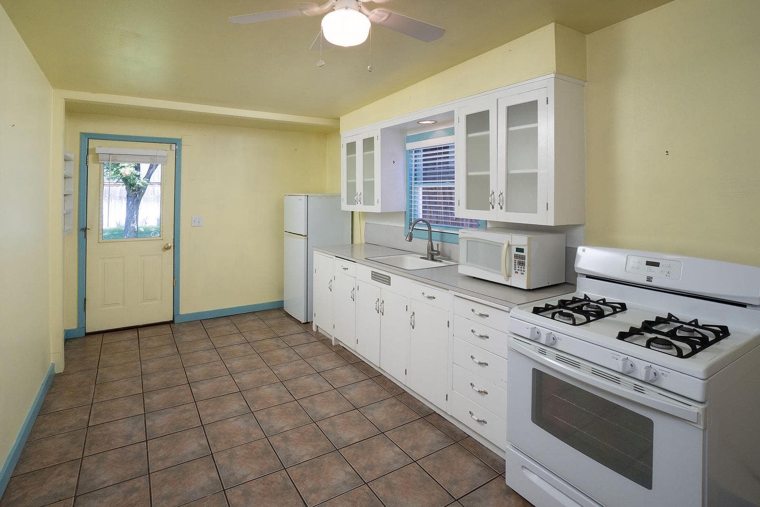 Convenient kitchen, back door directly to the covered patio for BBQ, outdoor eating, or relaxing.