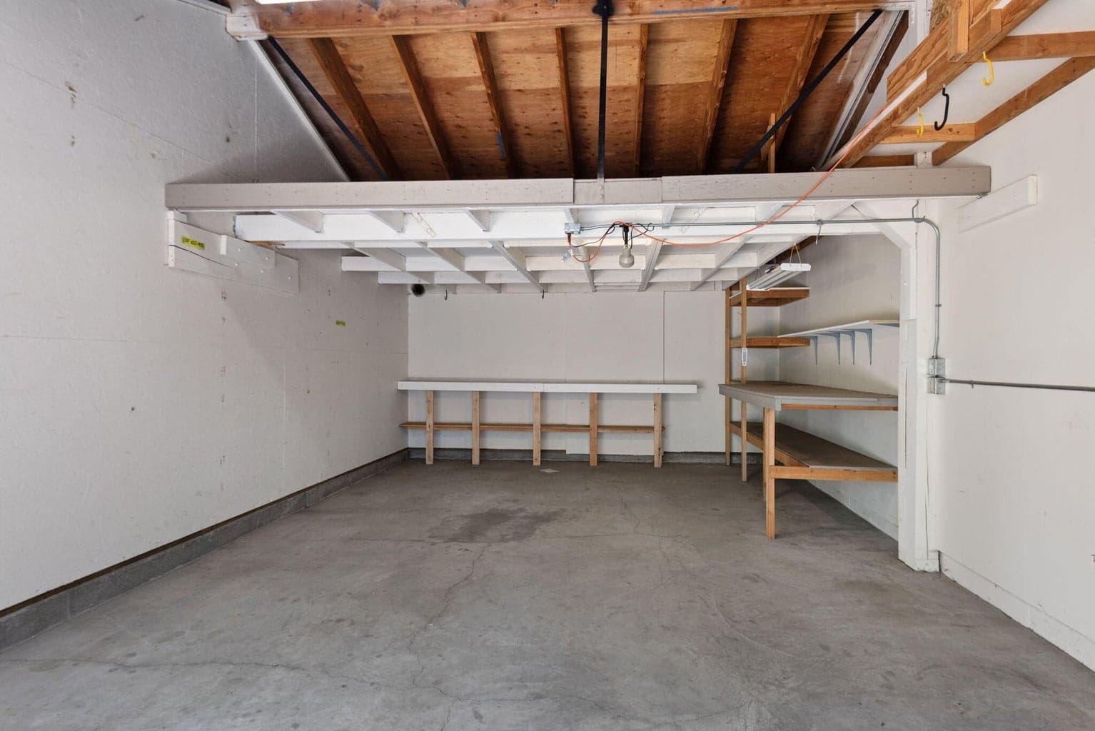 Third car garage with ample storage and work space