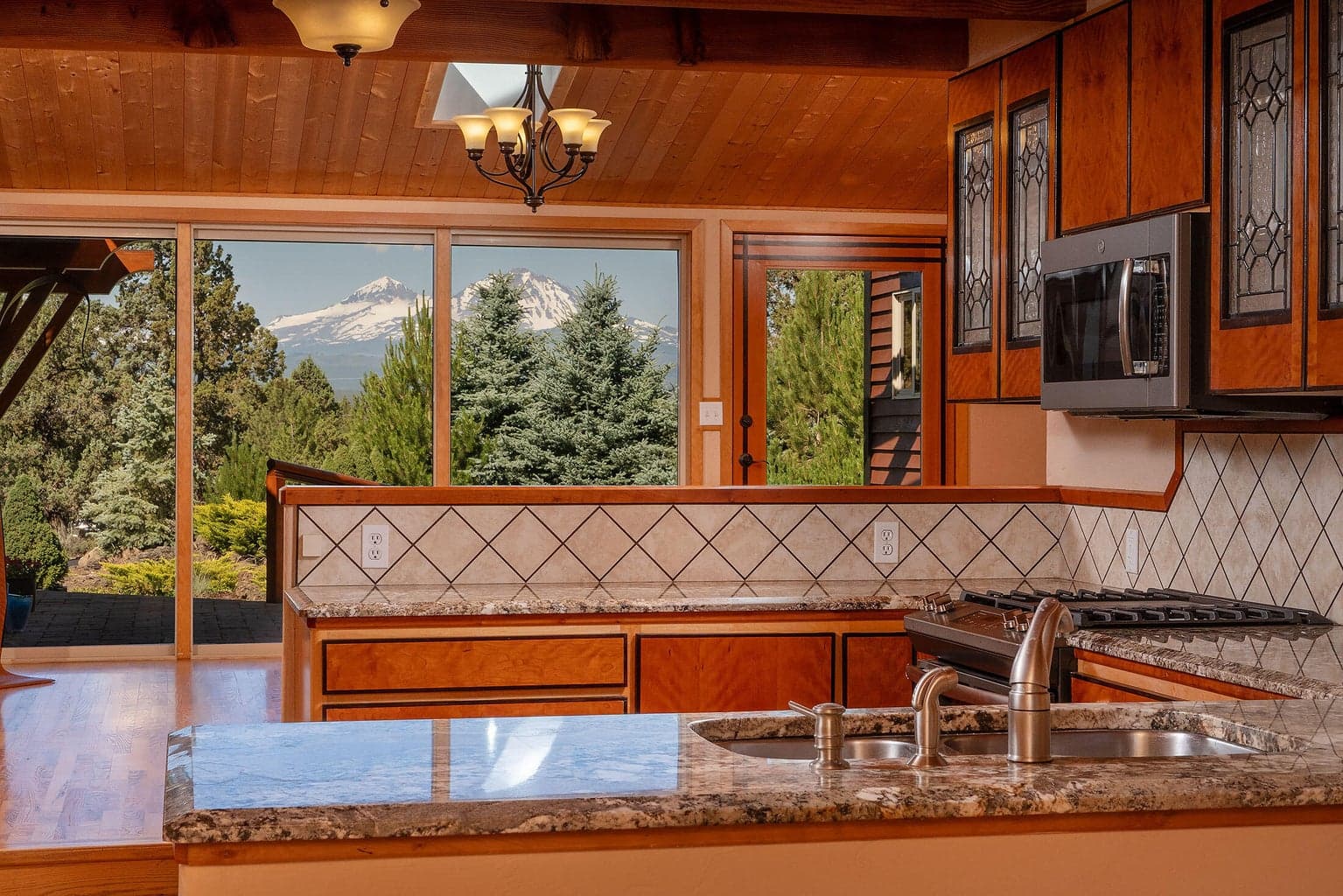 Kitchen has 3 Sisters Mt Views. Cherry cabinets w/rosewood trim, tile w/rosewood grout, stainless, beams, granite