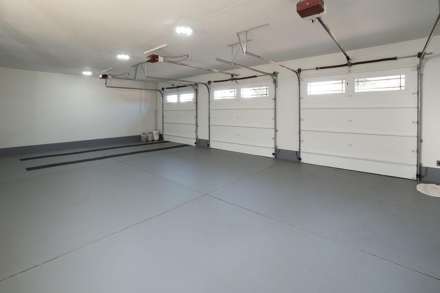 Outstanding 3 car garage with sealed floor and storage