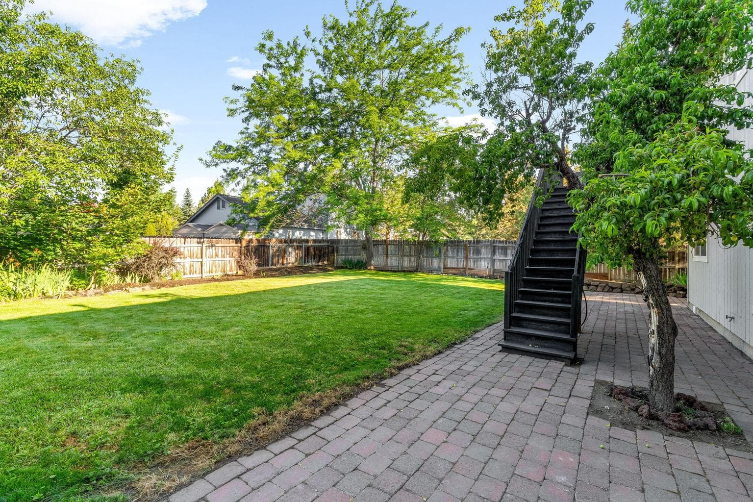 Stairs from back deck to fully fenced back yard.