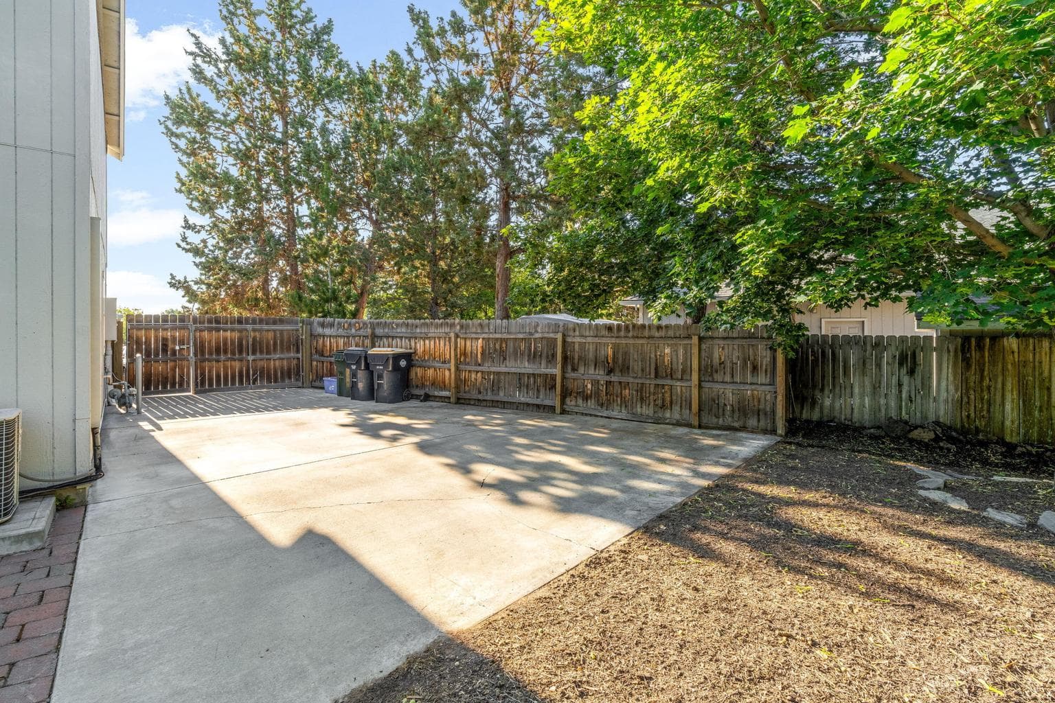RV parking on side of house, behind fence.