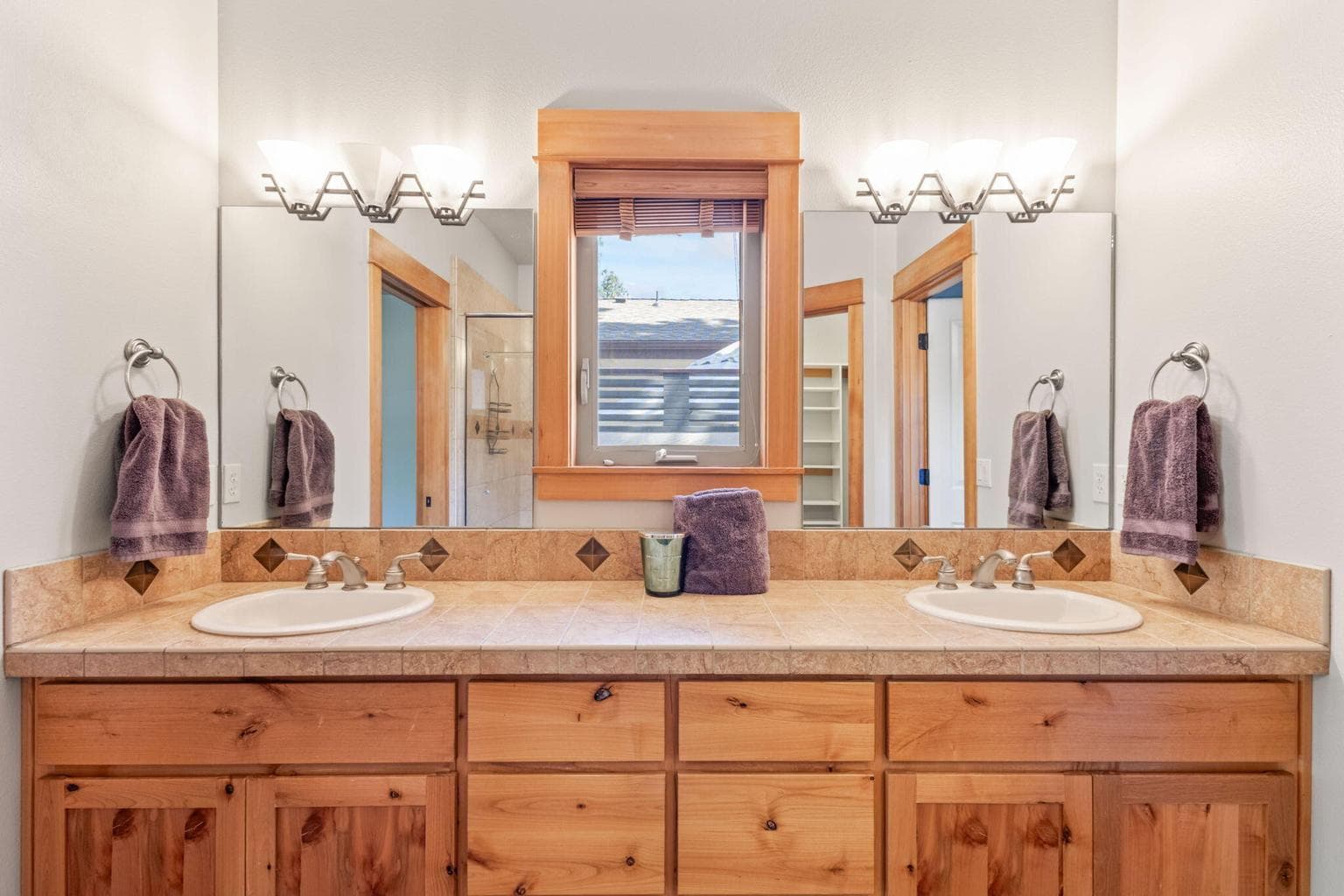Primary ensuite with dual vanity sinks, water closet, tiled shower, large walk in closet.