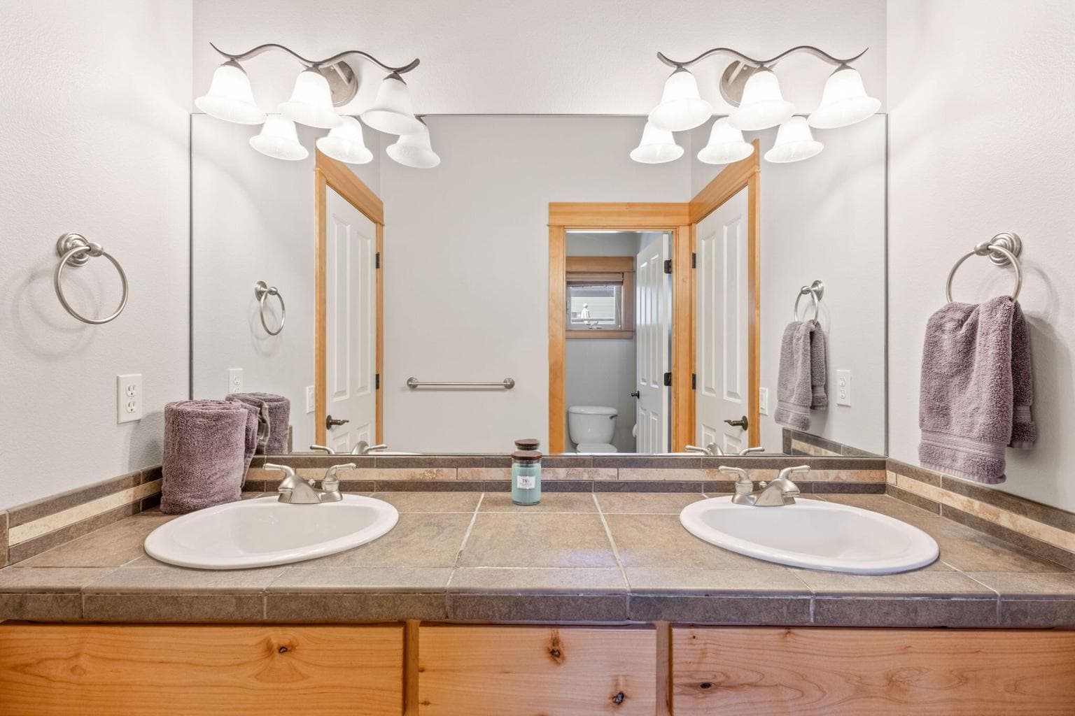 Main level guest bathroom with double sinks and separation for tub and toilet room.