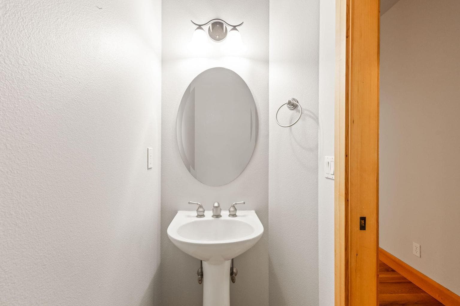 Main level 1/2 bath with pedestal sink.
