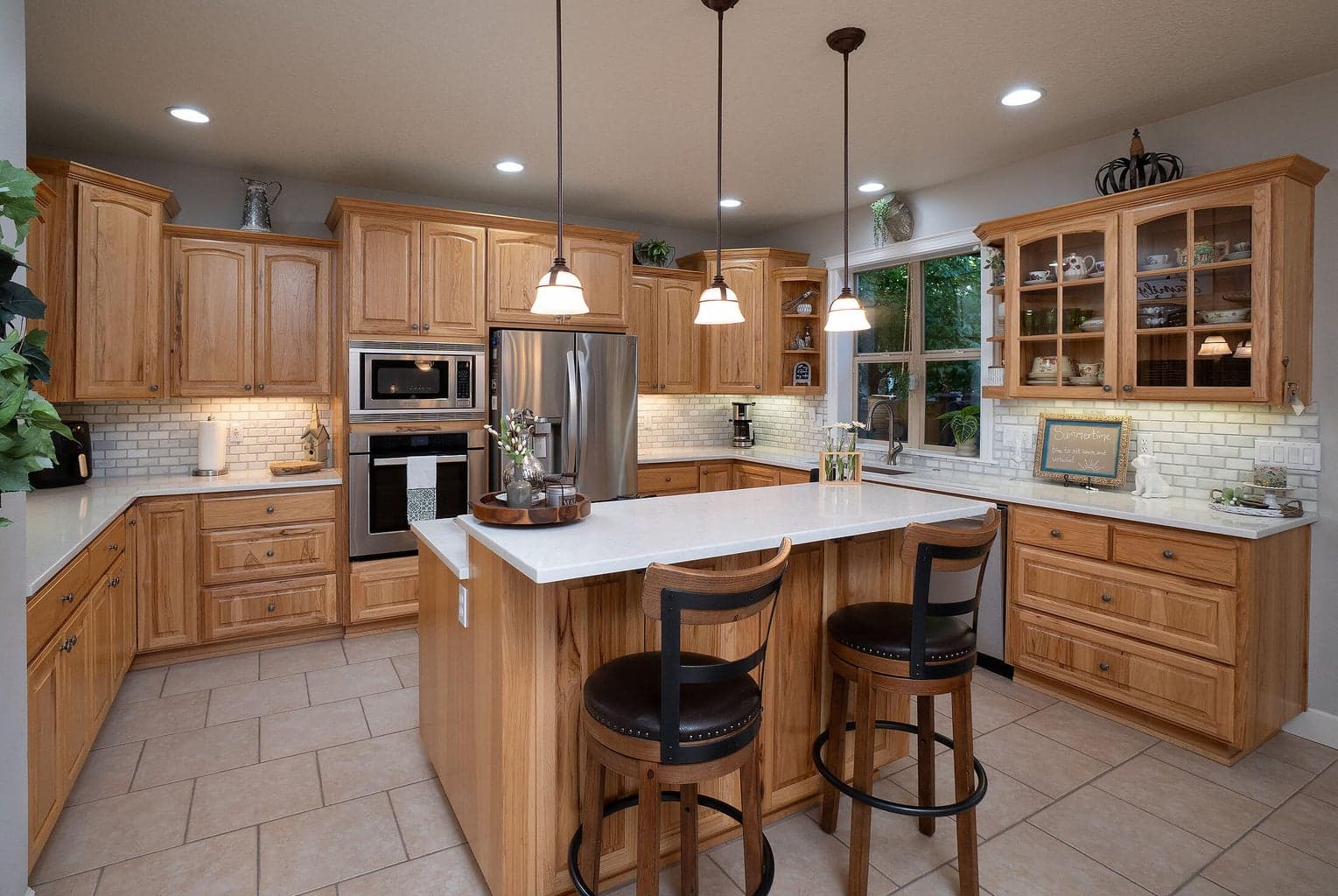 The kitchen has been recently updated with quartz counters, tile backsplash, and appliances.
