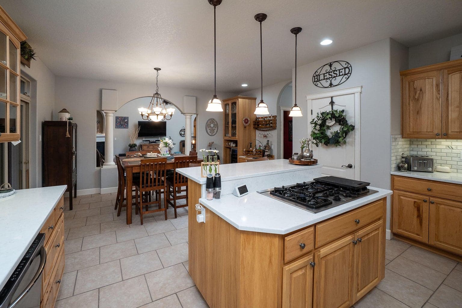 The kitchen features tile flooring, hickory cabinets, new sink and faucet.