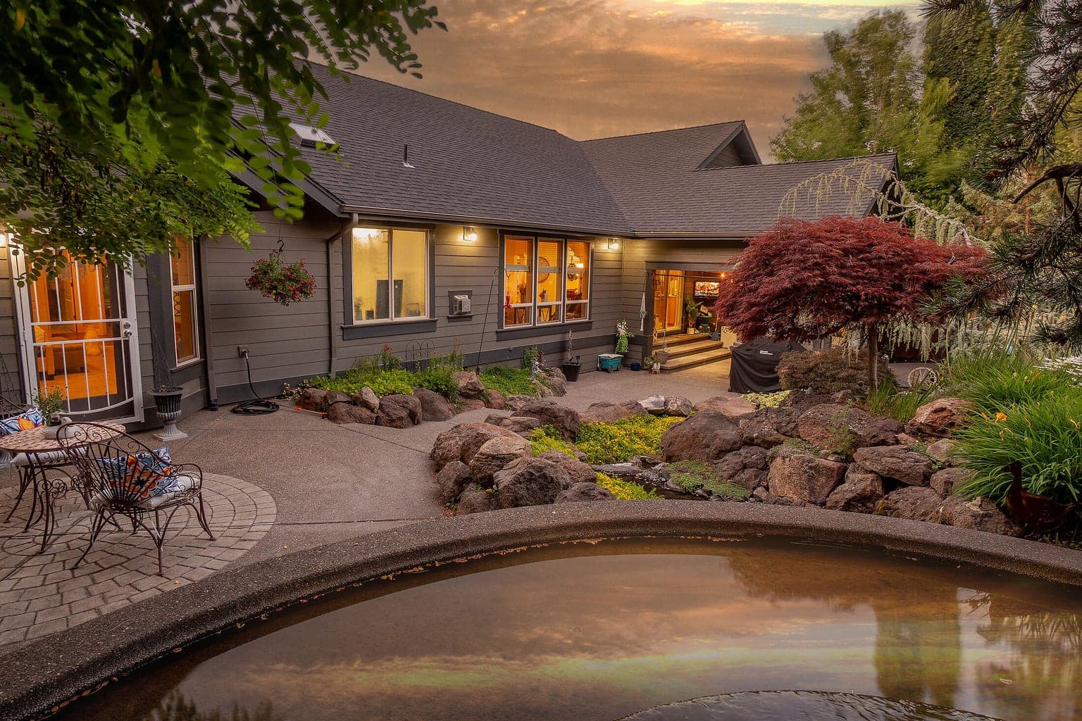 The concrete pond feeds the stream all the way to the other end of the yard.