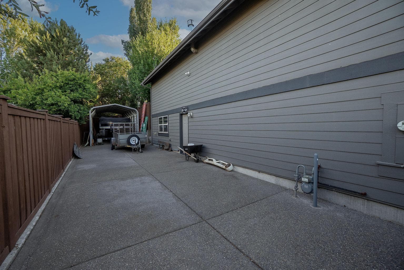 Huge gated, concrete RV parking area next to the home is easily accessible and has RV hookups.