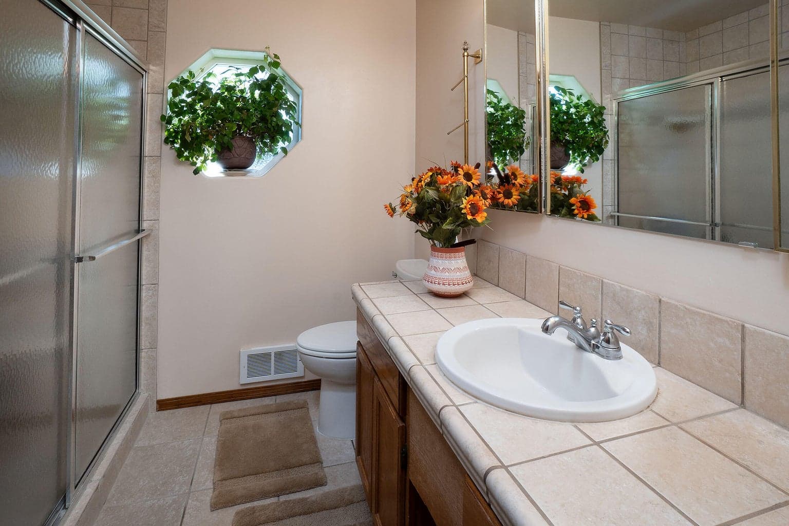 Master bath with tile couners, floors & shower.