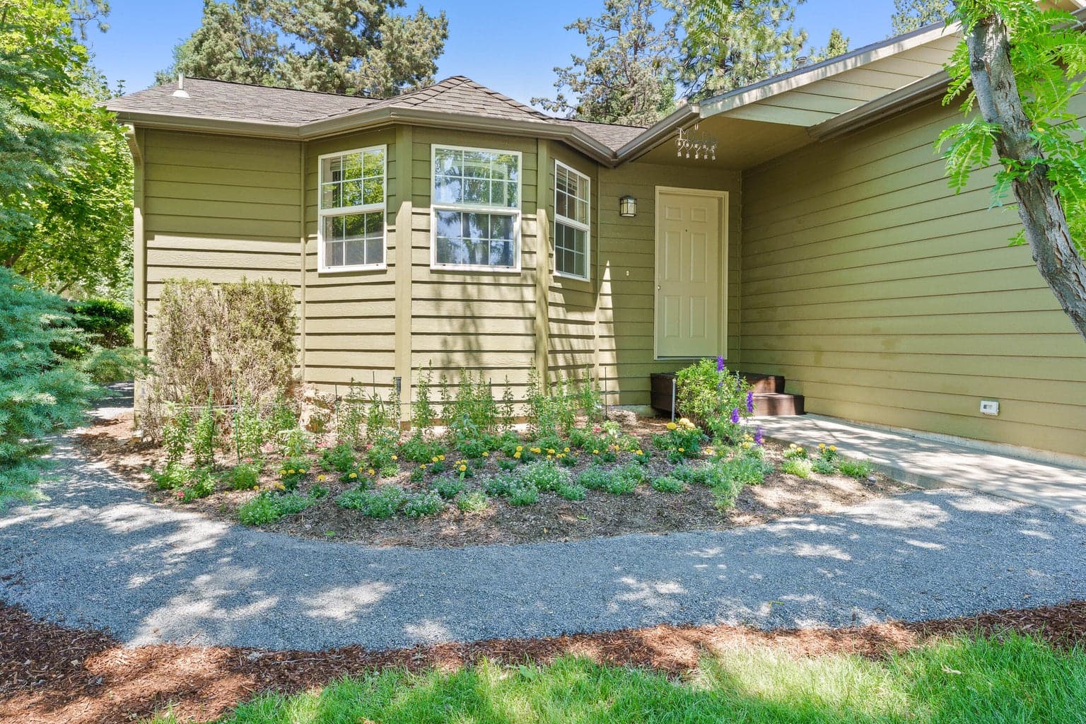 Beautifully landscaped front yard with path to backyard secret garden
