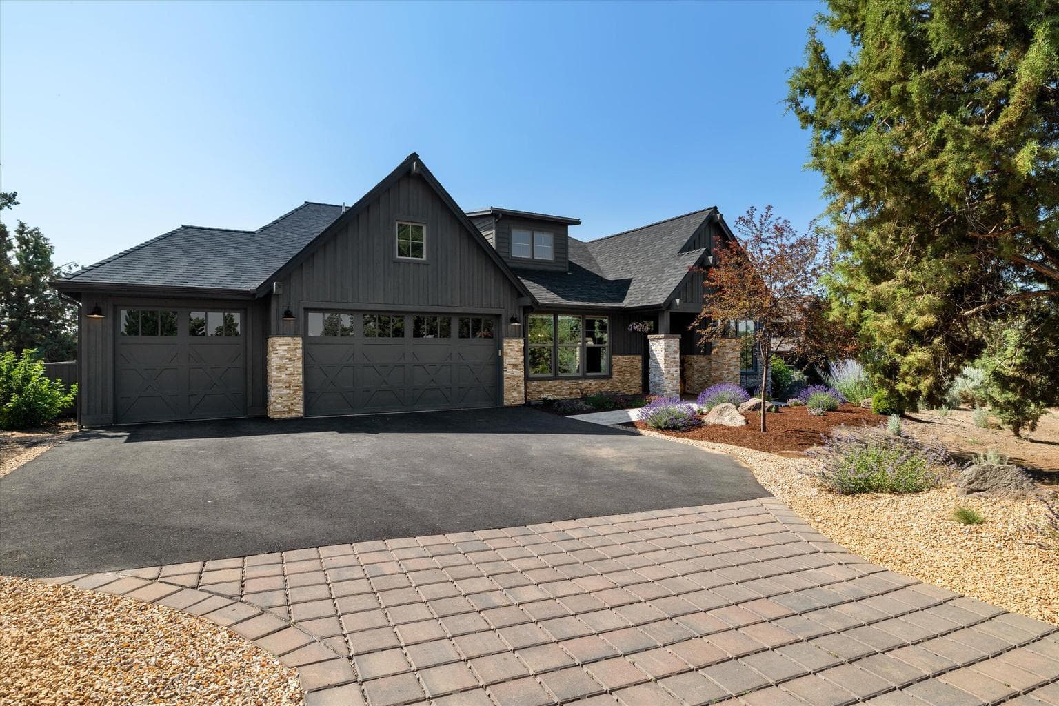 Stone accents and landscaped front yard. Three car garage