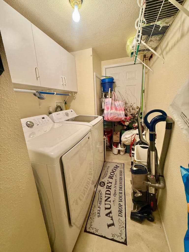 Laundry room with man door to outside.