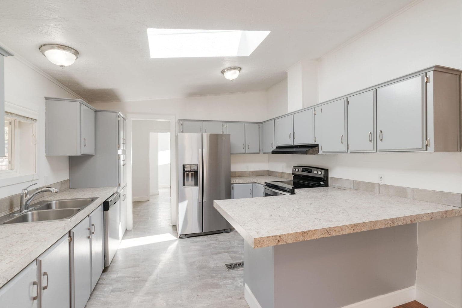New countertops in kitchen and stainless steel appliances.