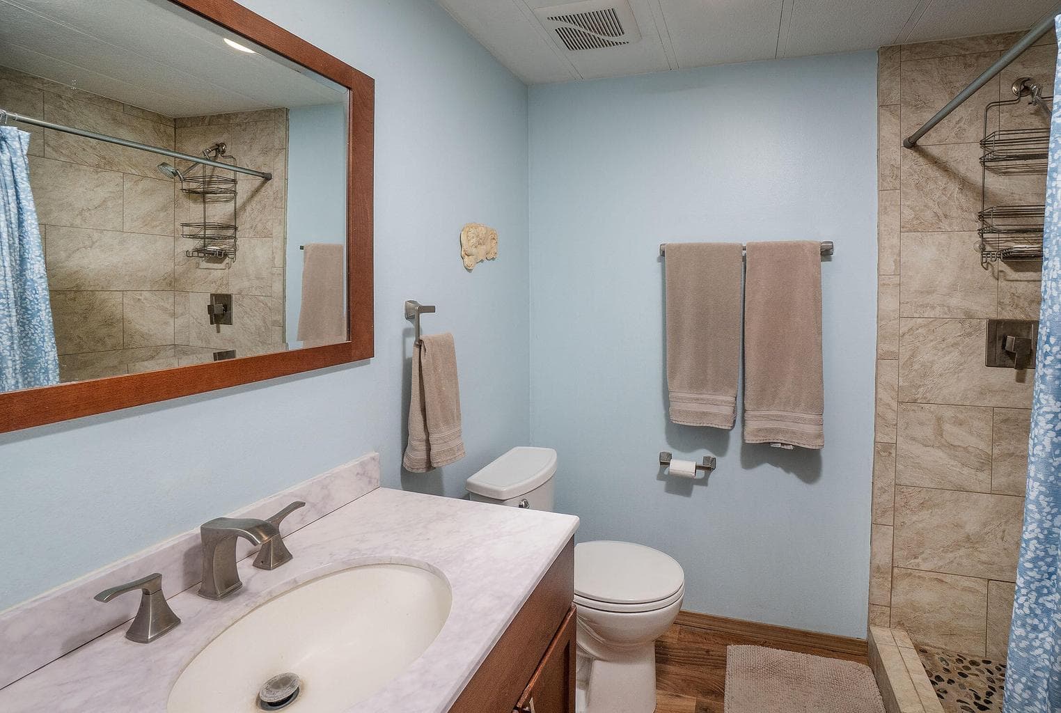 Updated full bath with tile shower and newer vanity.