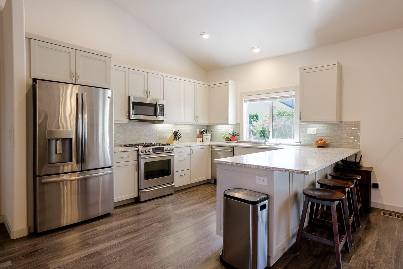 GE Profile Refrigerator & Range/Oven with Warming Drawer. Bosch Dishwasher, Solid Surface Counters, Hot Water Dispenser & Under Cabinet Lighting