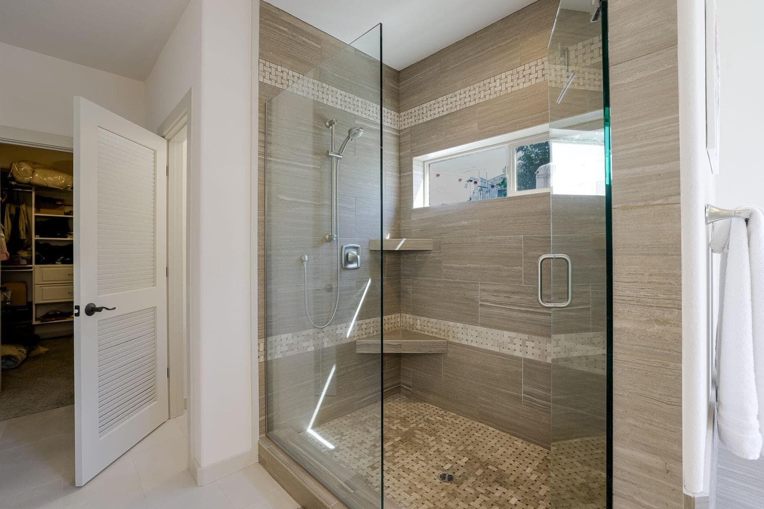 Tiled Walk-in Shower with 2 Shower Heads and Valves on Opposing Walls.
