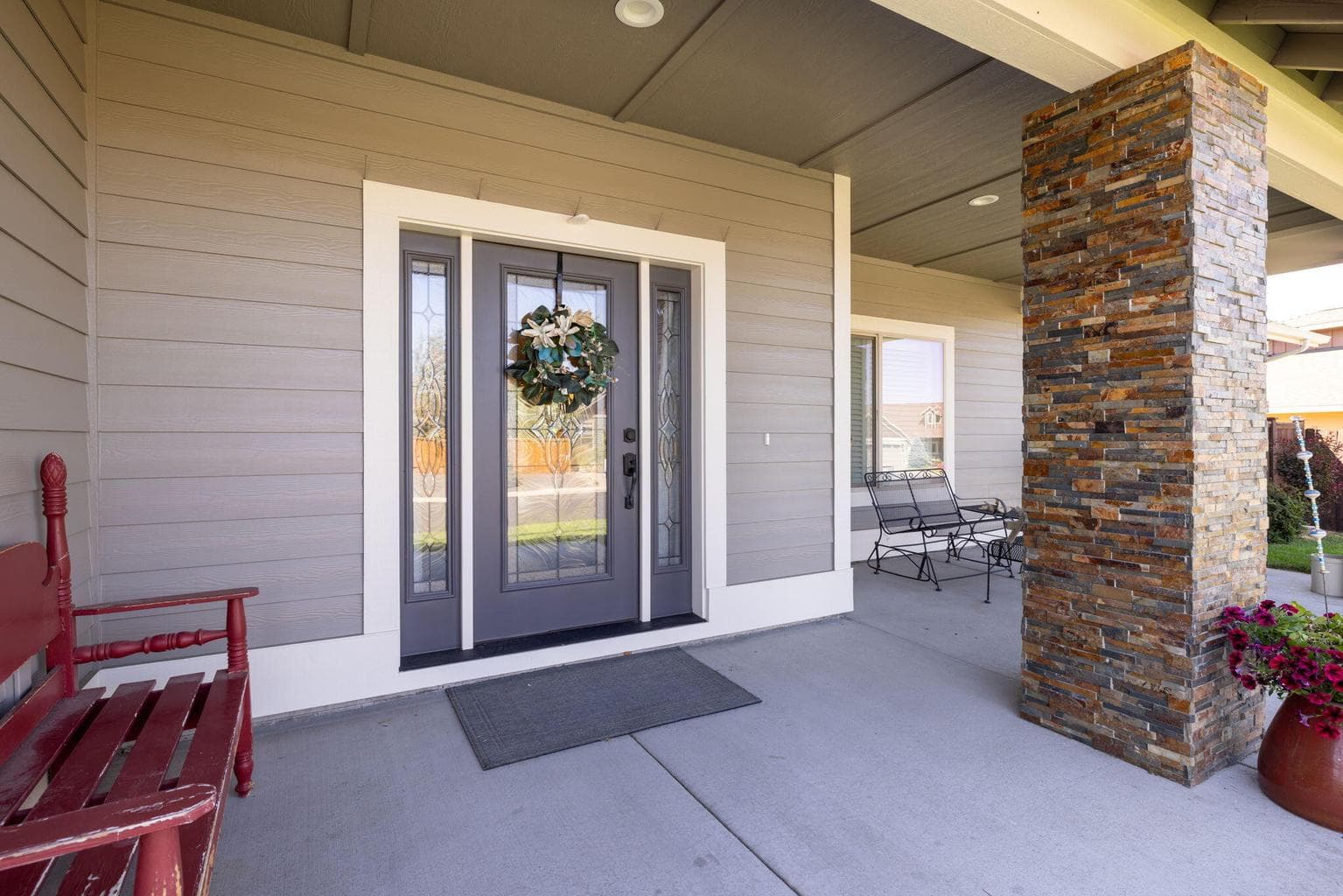 Covered Front Porch Entry With Dramatic Rock Columns