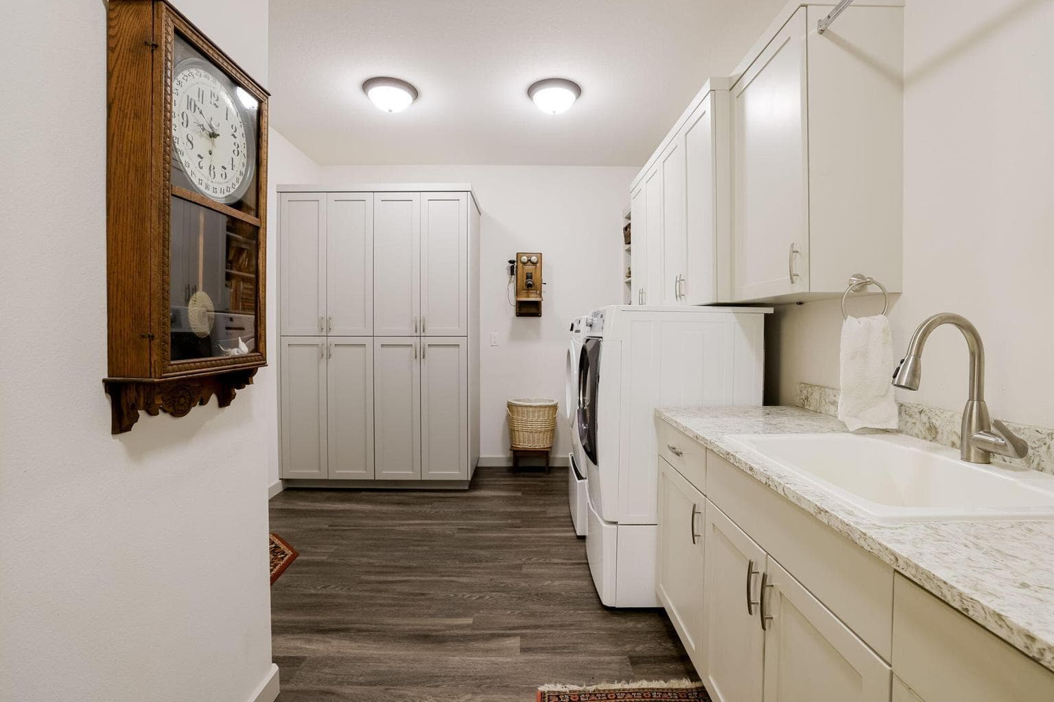 Upper and Lower Cabinetry, Sink, Bar to Hang Clothing, Shelves & Tall Storage Cabinets.