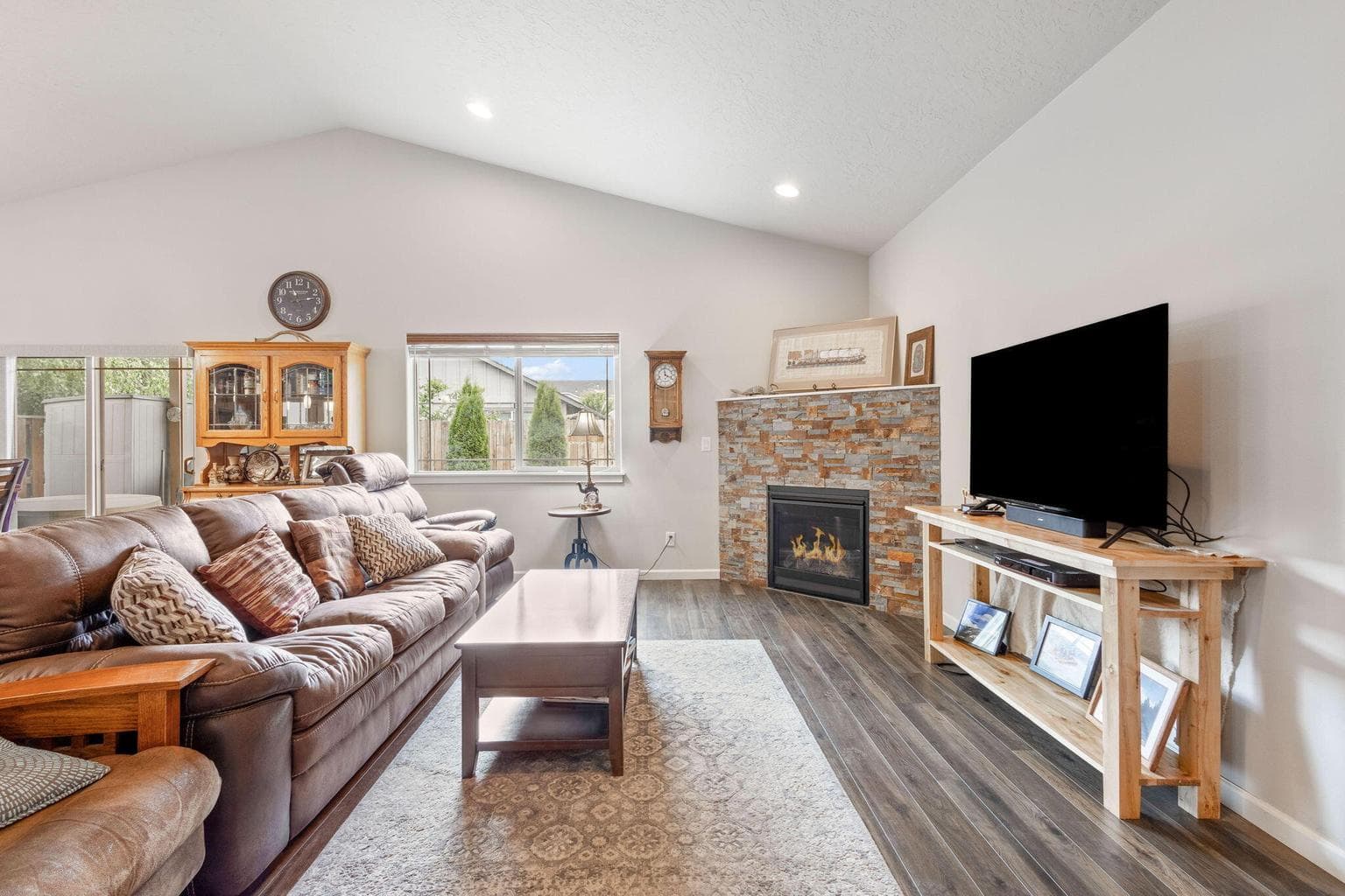 Living room with gas fireplace & vaulted ceiling