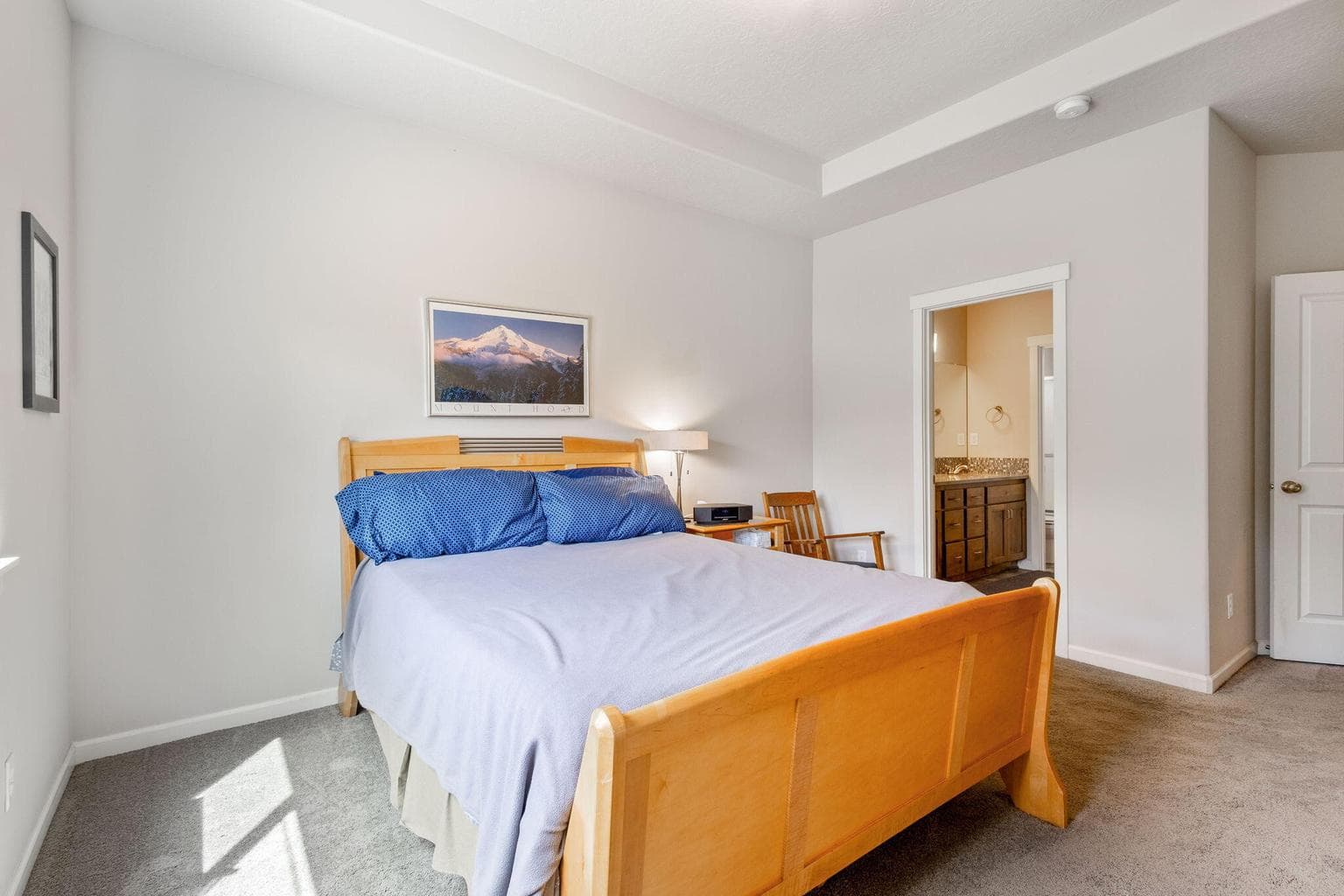 Primary bedroom with tray ceiling and ensuite
