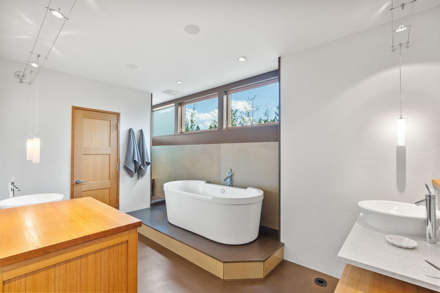 Separate vanities, soaking tub and dual head shower.