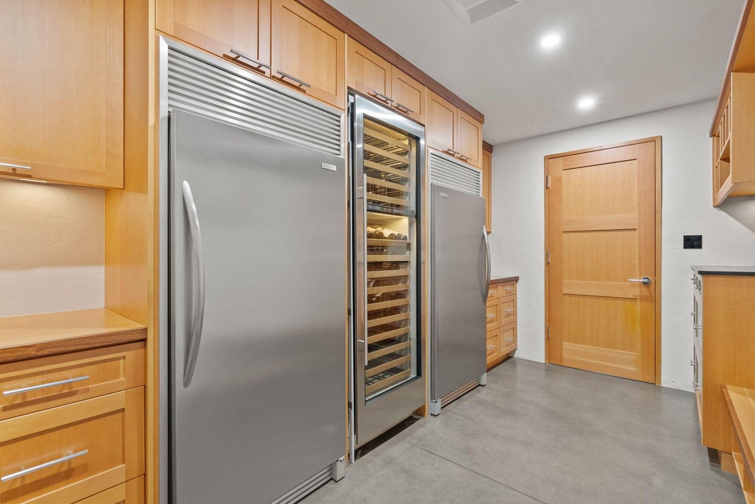 Full size freezer, refrigerator, wine cooler and U-Line ice maker for additional storage.