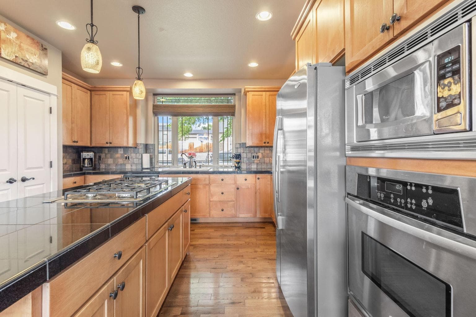 Huge granite island, pantry, tons of cupboard space!