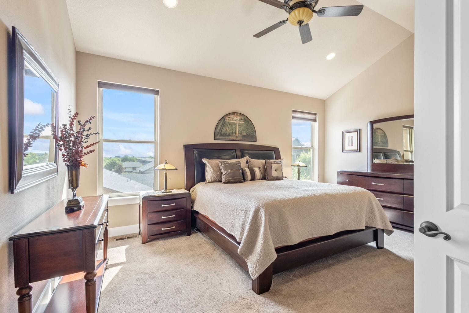 Oversized primary upstairs with vaulted ceiling, ceiling fan.