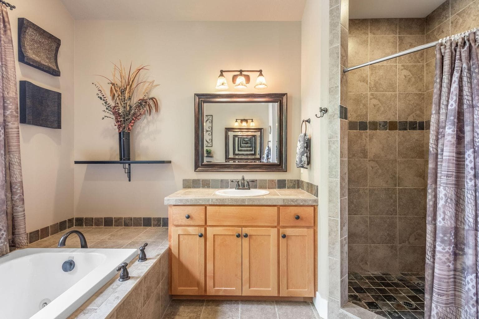 Tiled shower and 2nd vanity sink.