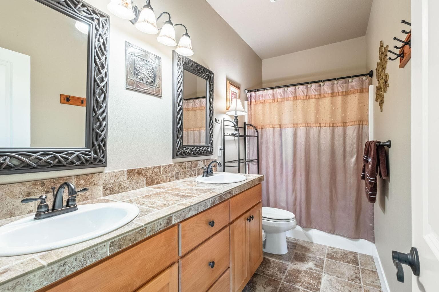 Guest bathroom with double vanity sinks.