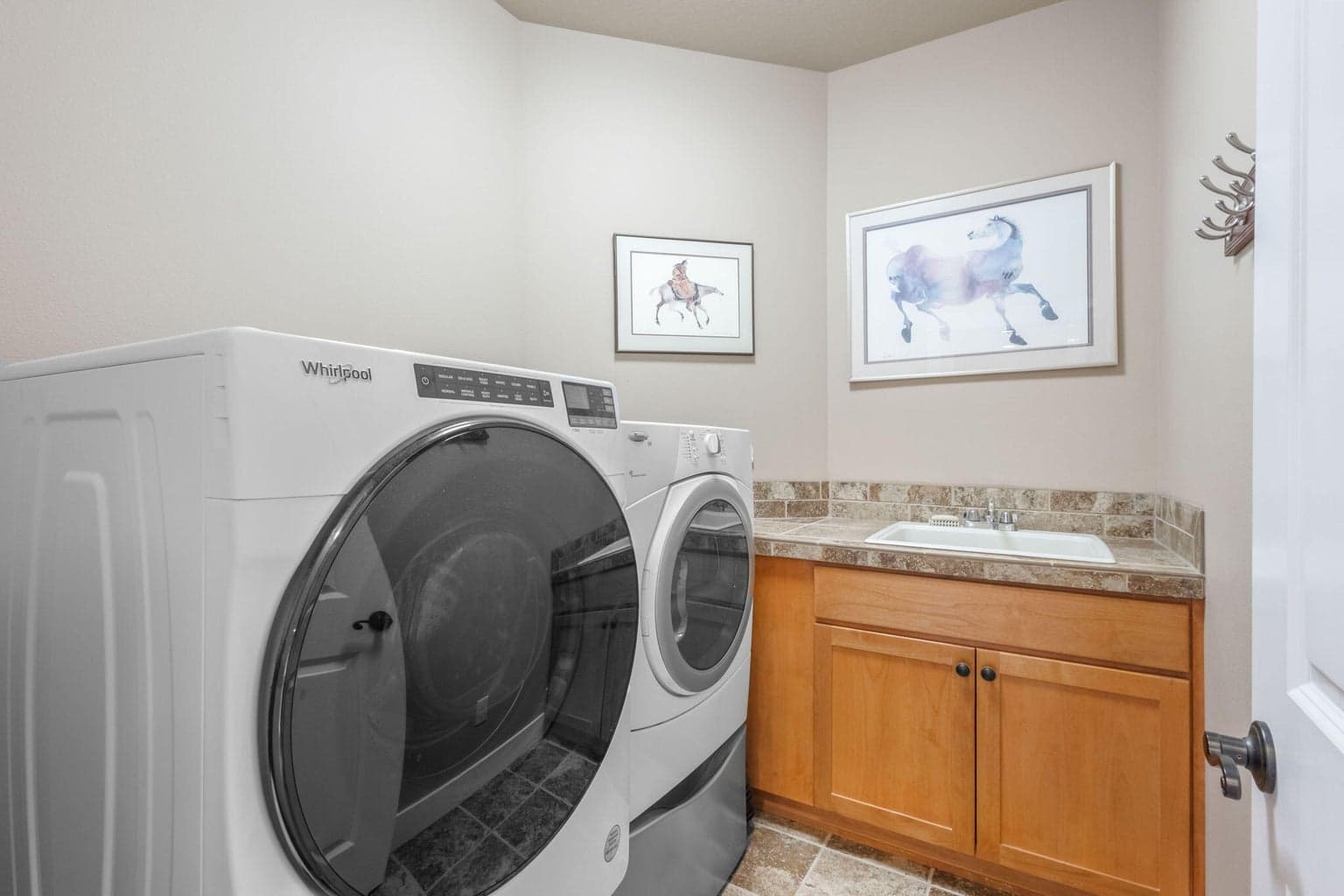 Laundry room with sink located upstairs. Washer and dryer are included in the sale.