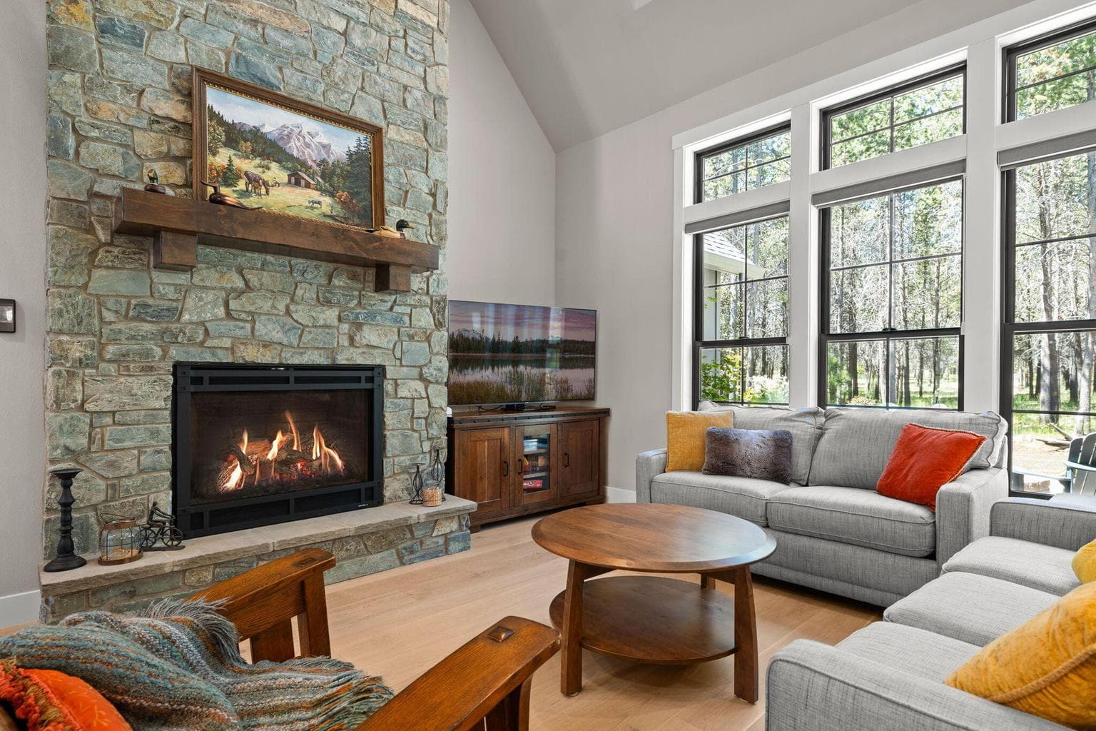 Large natural stone gas fireplace and windows with custom blinds